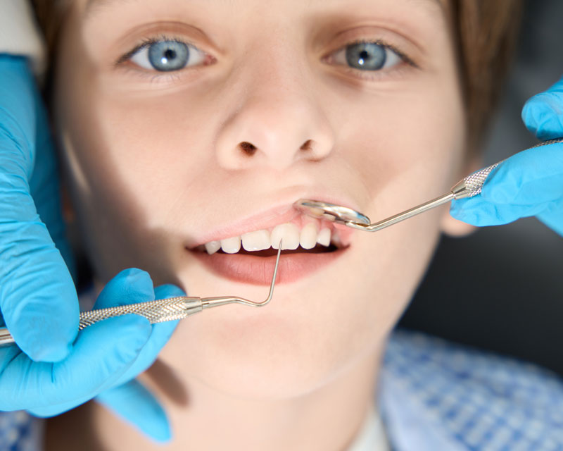 boy having teeth checked